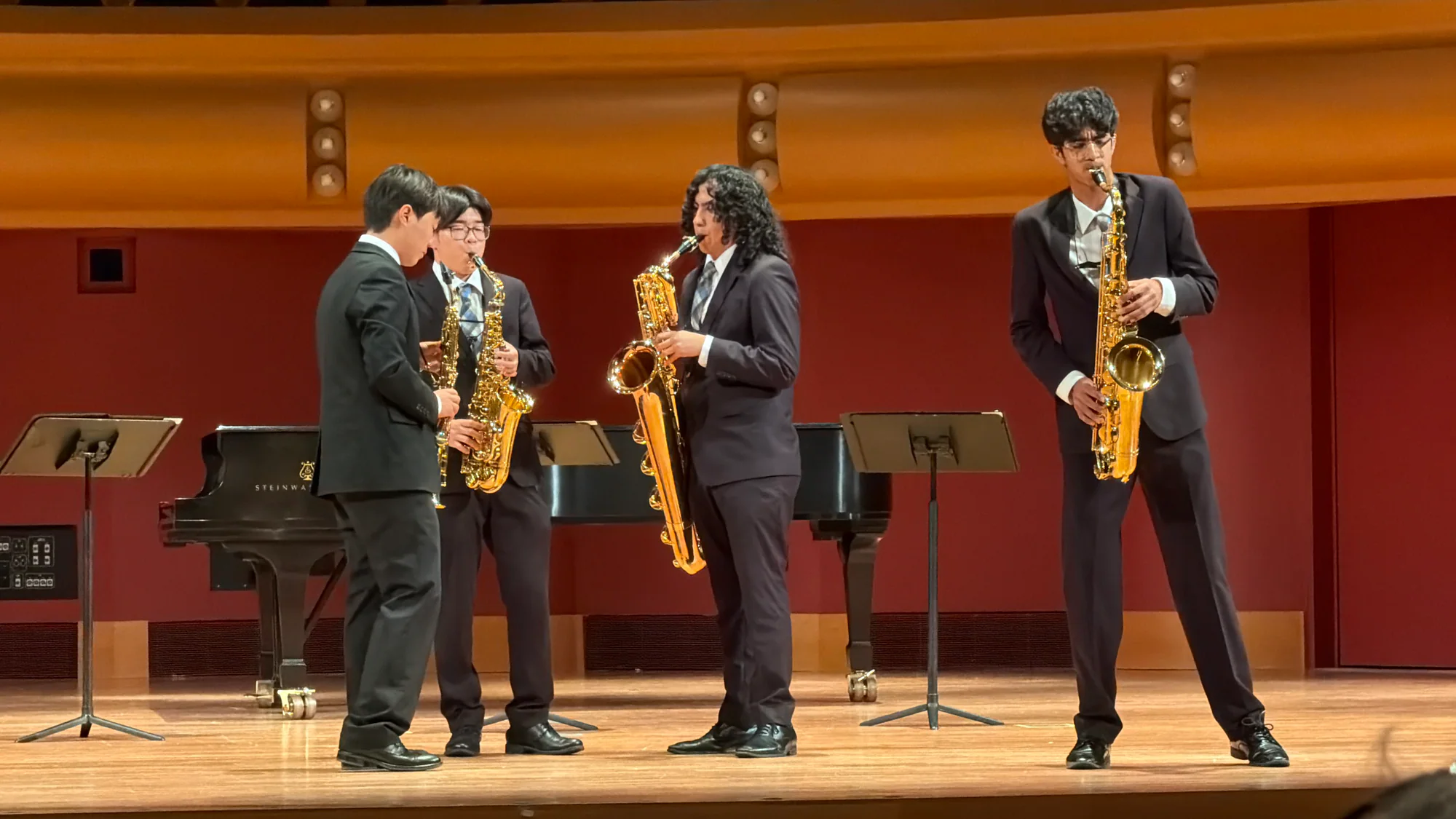 Armaan performing saxophone on stage